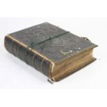 A Victorian family bible, bound in tooled black leather