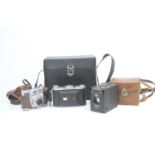 A collection of vintage photography equipment to include a Kodak Retinette SLR camera