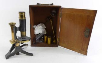 A brass monocular microscope, stamped J White Glasgow to the base, cased with accessories