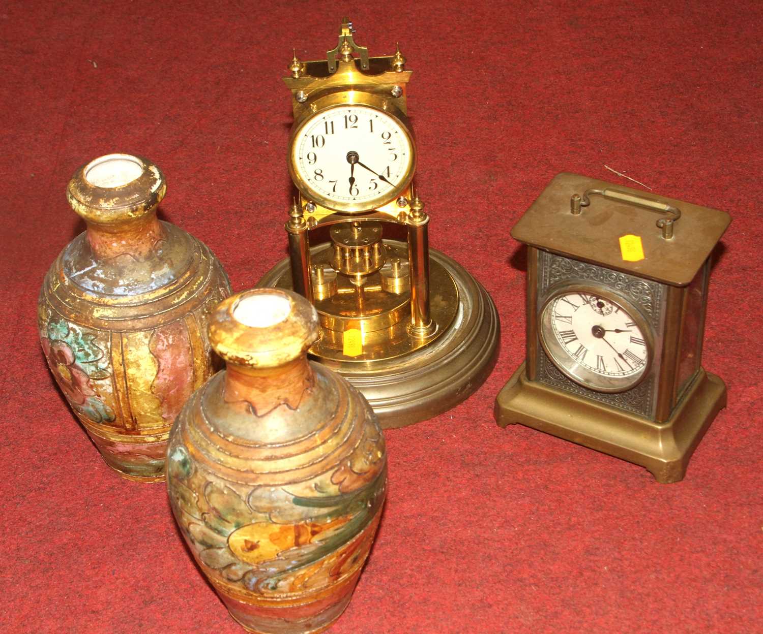 An early 20th century brass and pewter mantel clock; together with a brass anniversary clock; and