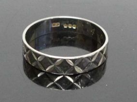 A modern silver and engraved wedding band, size N