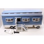 A well made wooden model of a travelling living quarters, finished in blue and cream with hinged