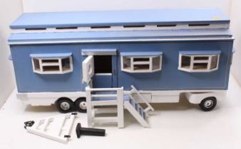 A well made wooden model of a travelling living quarters, finished in blue and cream with hinged