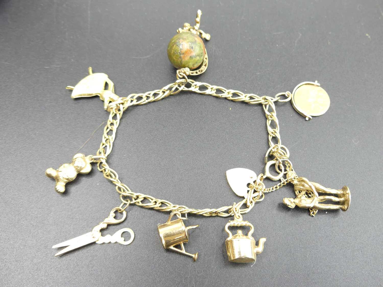 A modern 9ct gold bracelet, containing assorted principally 9ct gold charms, gross weight 20.1g - Image 2 of 2