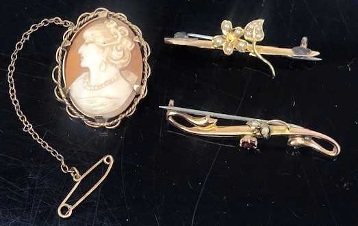 A 9ct gold, seed pearl and ruby bar brooch, with steel pin, 4cm; together with a 15ct gold and