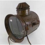 An early 20th century copper ship's spotlight, bearing a label for Yarmouth Stores, Ship Lamp