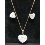 A modern 9ct gold and cz set heart shaped pendant on finelink neck chain, together with matching ear