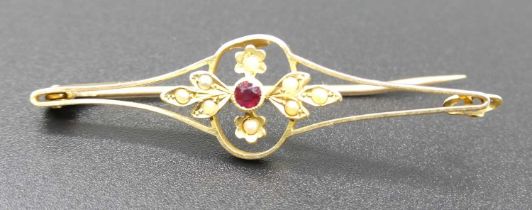 A 15ct gold seed pearl and ruby set openwork bar brooch, 3.5g, 5cm