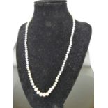 A graduated freshwater pearl single string necklace, with yellow metal clasp stamped 750, length