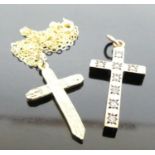 A modern 9ct gold cross pendant on finelink neck chain; together with a 9ct gold and cz set cross