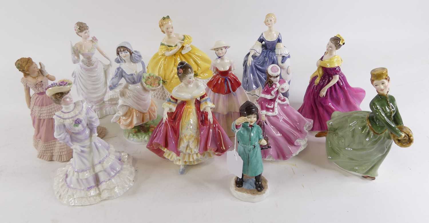 A collection of Royal Doulton, Wedgwood and Worcester pottery figures of ladies, largest h.22cm