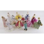 A collection of Royal Doulton, Wedgwood and Worcester pottery figures of ladies, largest h.22cm