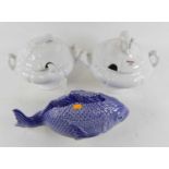 A pottery tureen in the form of a fish, w.41cm; together with two white glazed pottery tureens