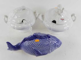 A pottery tureen in the form of a fish, w.41cm; together with two white glazed pottery tureens
