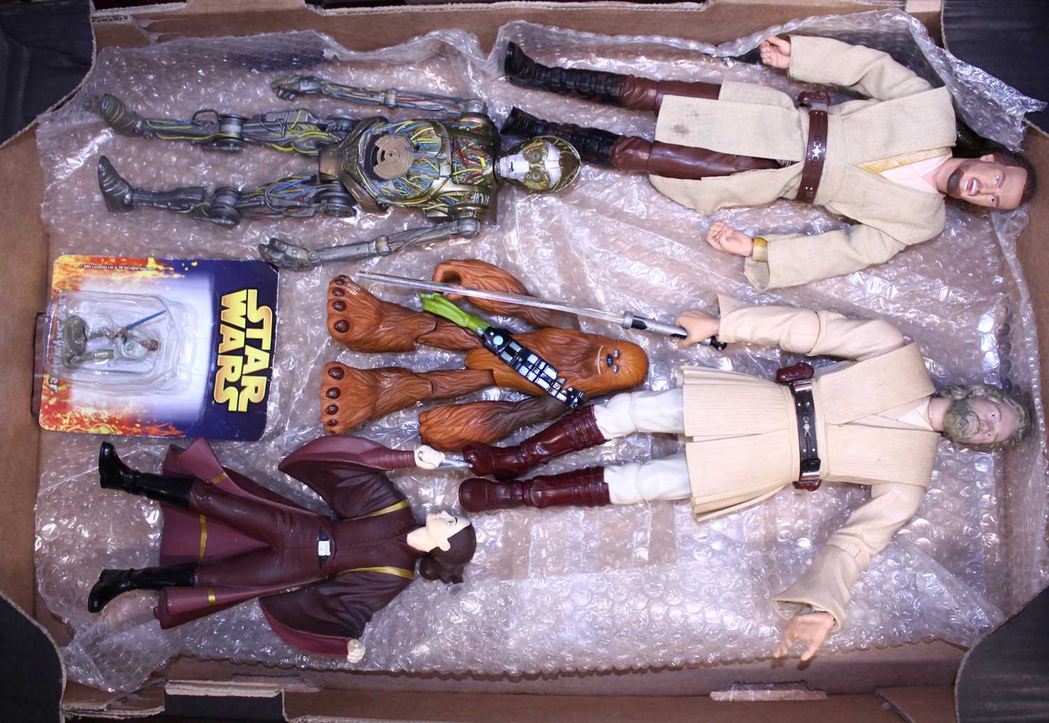 Two trays containing Star Wars related action figures, and others, to include a Star Wars