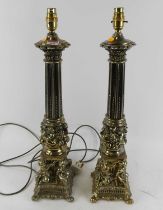 A pair of large modern gilt metal table lamps each having a fluted column supported by four