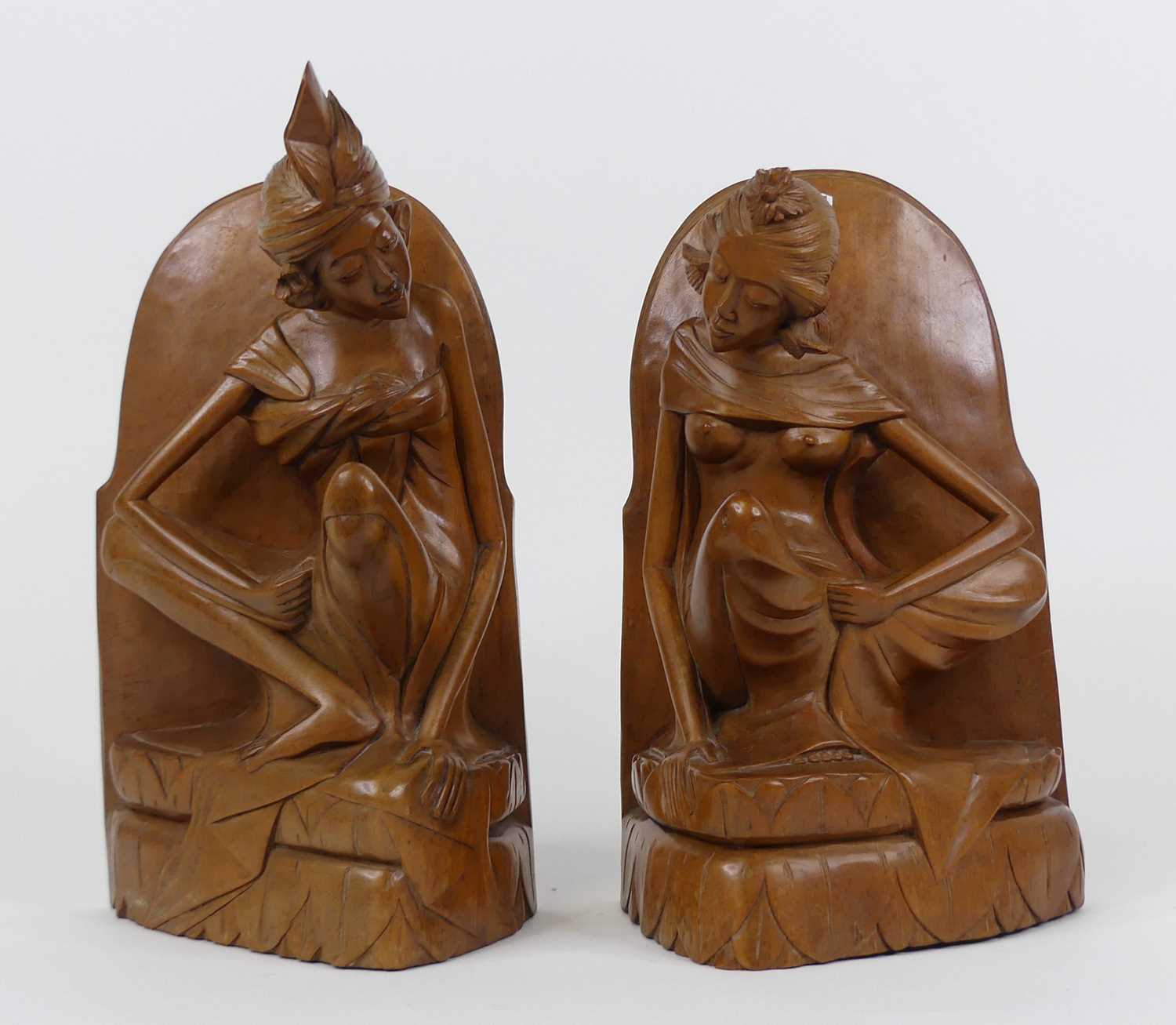 A pair of Asian carved hardwood figural bookends, each height 30cm