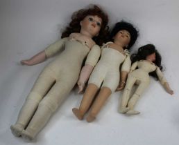 A Bruj bisque headed doll; together with two other similar (3)
