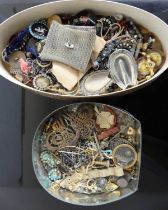 A lithograph printed tin and contents of assorted costume jewellery, to include belt buckle, hat-pin