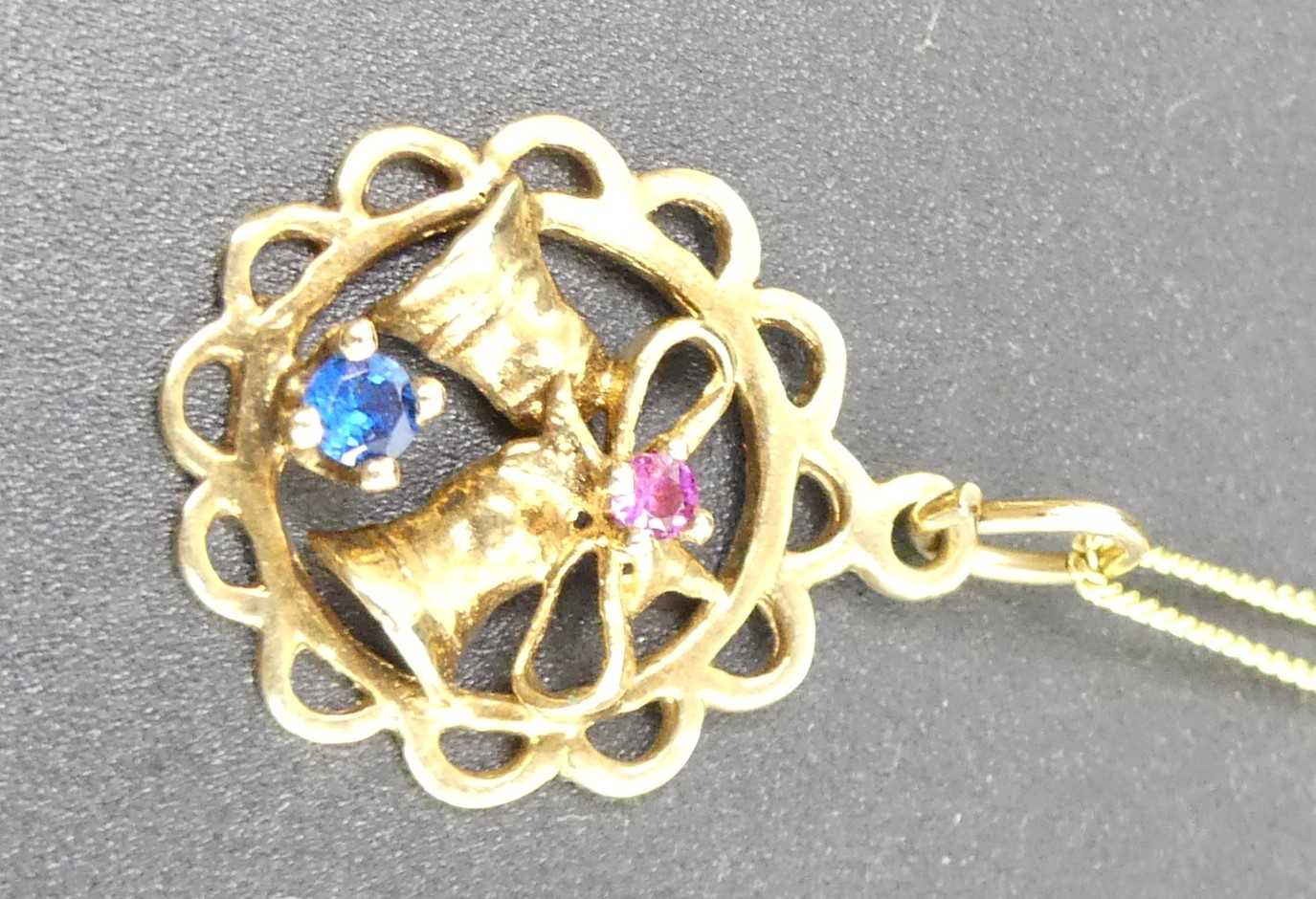 A modern 9ct rose gold, sapphire and ruby set openwork pendant, dia.17mm, on 9ct gold finelink - Image 2 of 3
