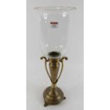 A brass table candlestick, having a clear glass shade, h.60cm