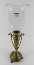 A brass table candlestick, having a clear glass shade, h.60cm