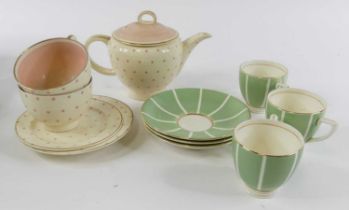 A Susie Cooper part tea service on a cream ground with pink star decoration, printed mark verso,