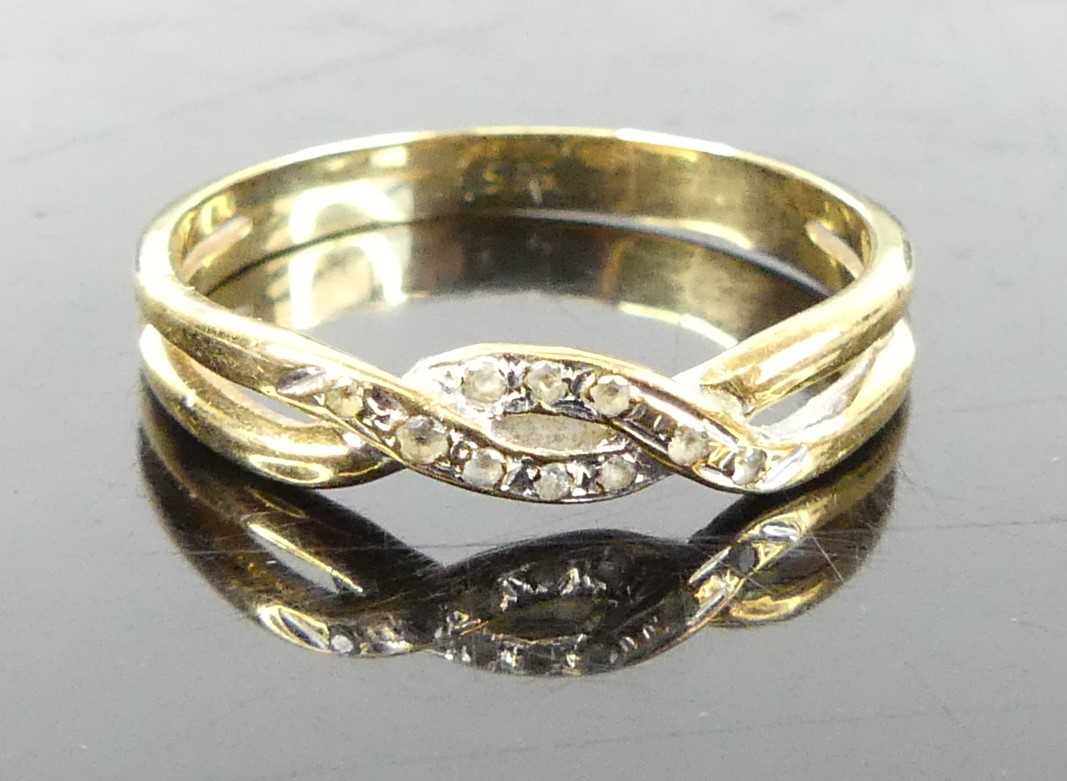 A yellow metal and cz set band ring, stamped 585 and tests as approx 14ct gold, 2.1g, size P/O
