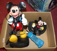 A Disney Mickey Mouse backpack landline telephone by Tyco and one other