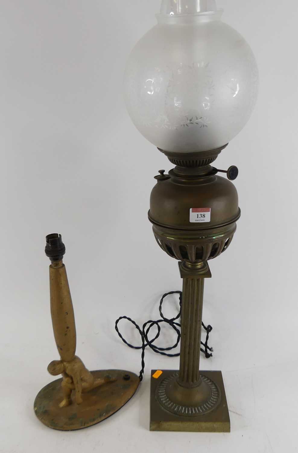 A Victorian brass oil lamp, having an acid etched globe shade, h.76cm; together with a figural