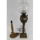 A Victorian brass oil lamp, having an acid etched globe shade, h.76cm; together with a figural