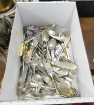 A collection of silver plated flatware to include table forks, fish knives, and serving spoons etc