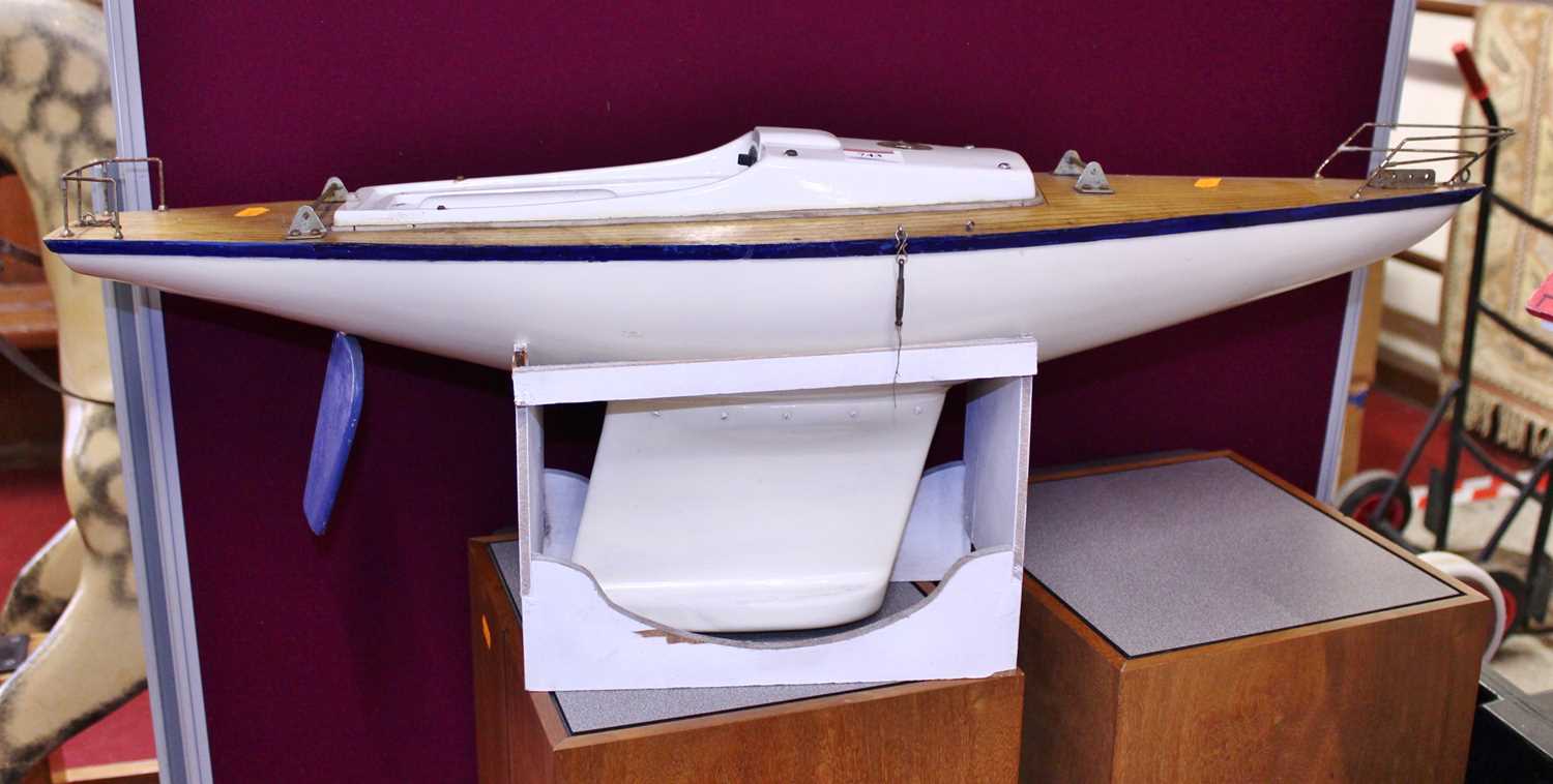 A wooden kit built model boat with stand