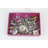 A collection of vintage souvenir spoons and trinket boxes