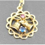 A modern 9ct rose gold, sapphire and ruby set openwork pendant, dia.17mm, on 9ct gold finelink