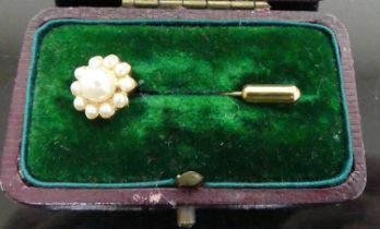 A gilt metal and faux pearl set tie-pin, in fitted leather case, early 20th century