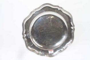 A German silver dish having a shaped reeded rim and sunken well with engraved inscription, maker