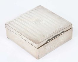 A George V silver clad table cigarette box, of typical hinged rectangular shape, having engraved