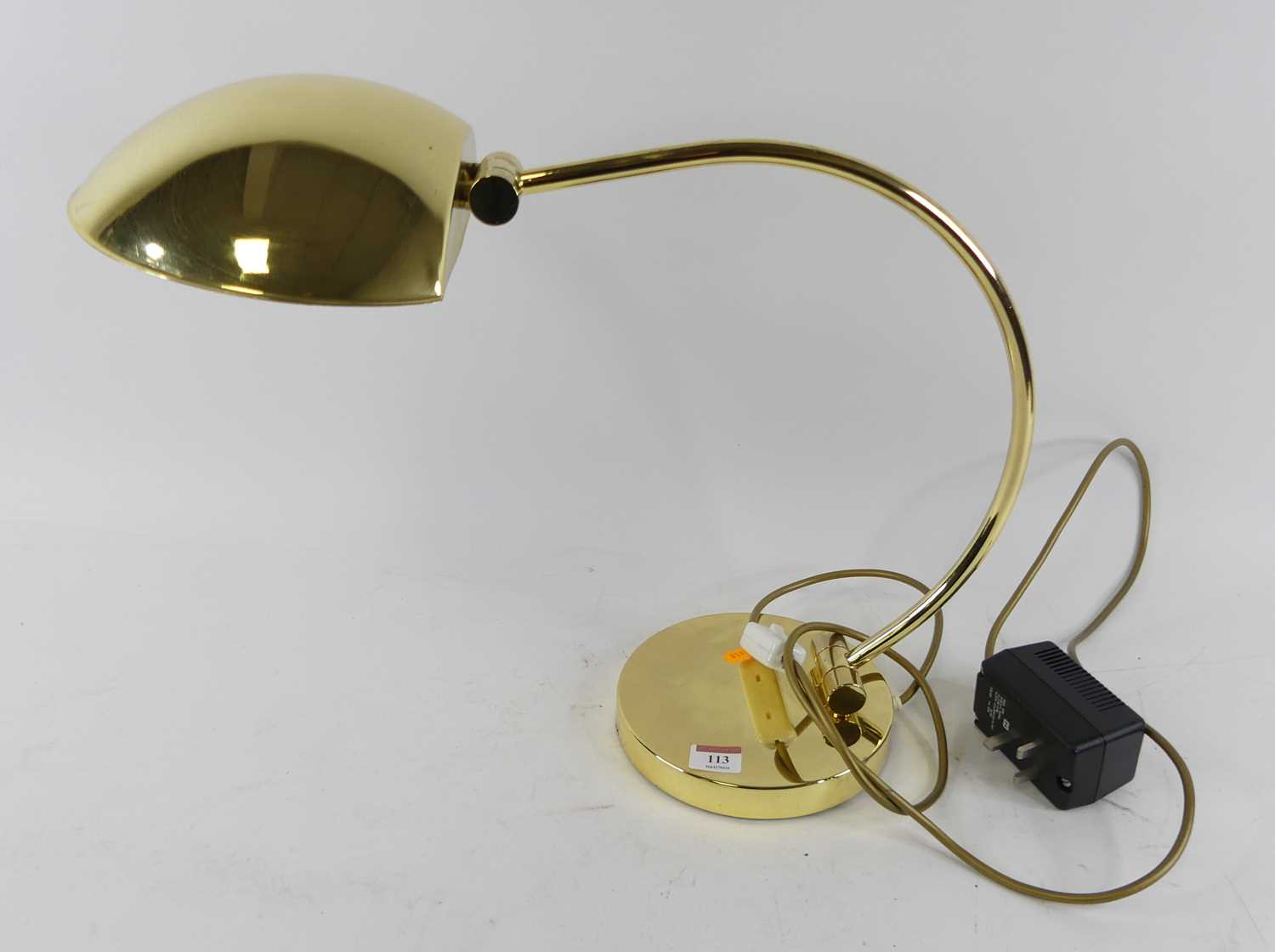 A modern brass adjustable table lamp