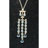 A modern 9ct gold blue topaz set pendant on finelink neck chain, sponsor QVC, 4.4g, pendant h.4.9cm