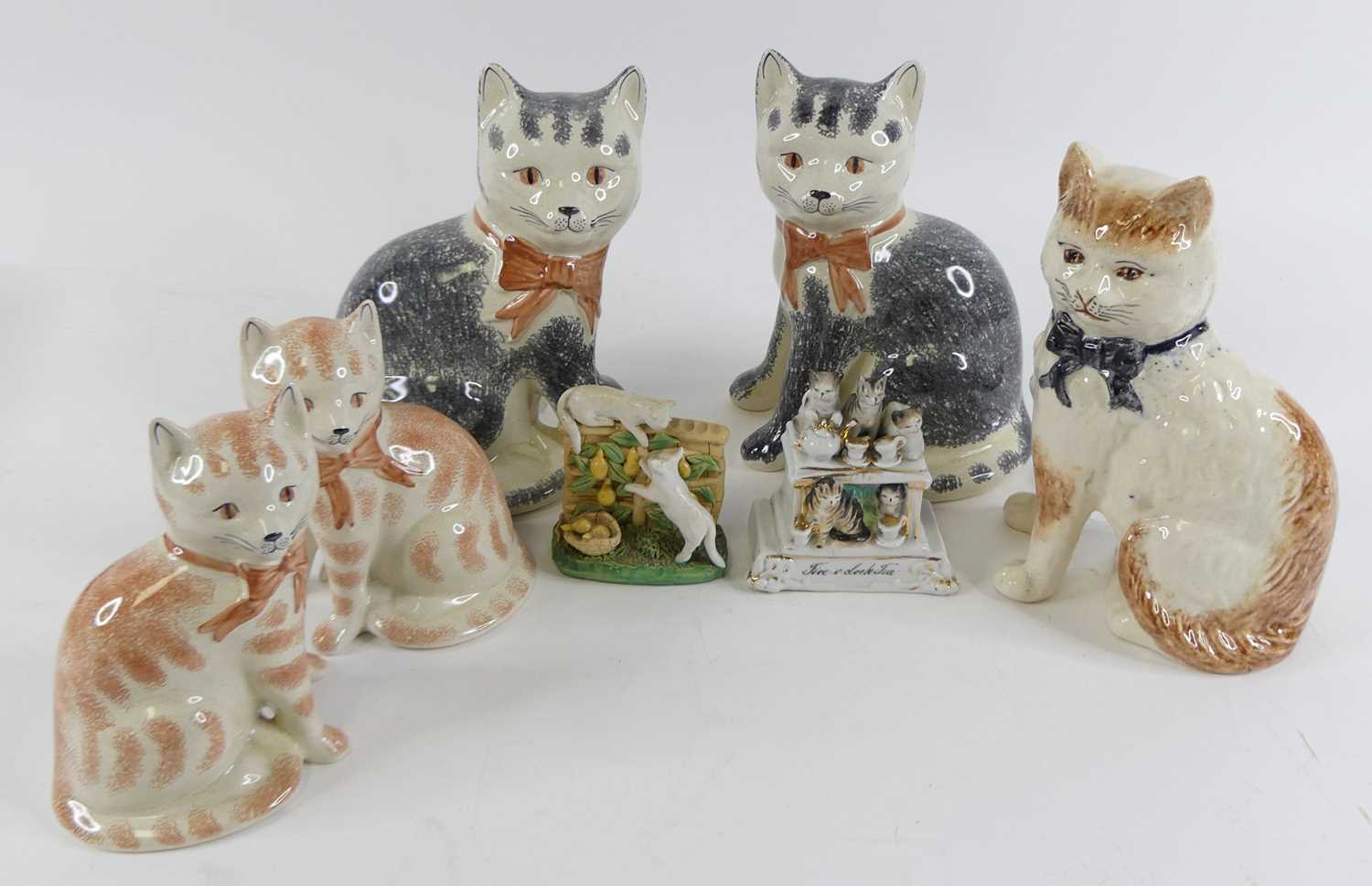 A pair of Rye pottery models of seated cats, together with various other cat figures, One of