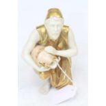 A Royal Worcester figure of a water-carrier, heightened in gilt, h.16cm