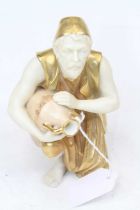 A Royal Worcester figure of a water-carrier, heightened in gilt, h.16cm