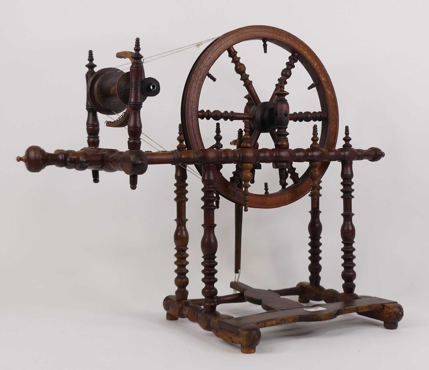 A turned wood spinning wheel, height 51cm