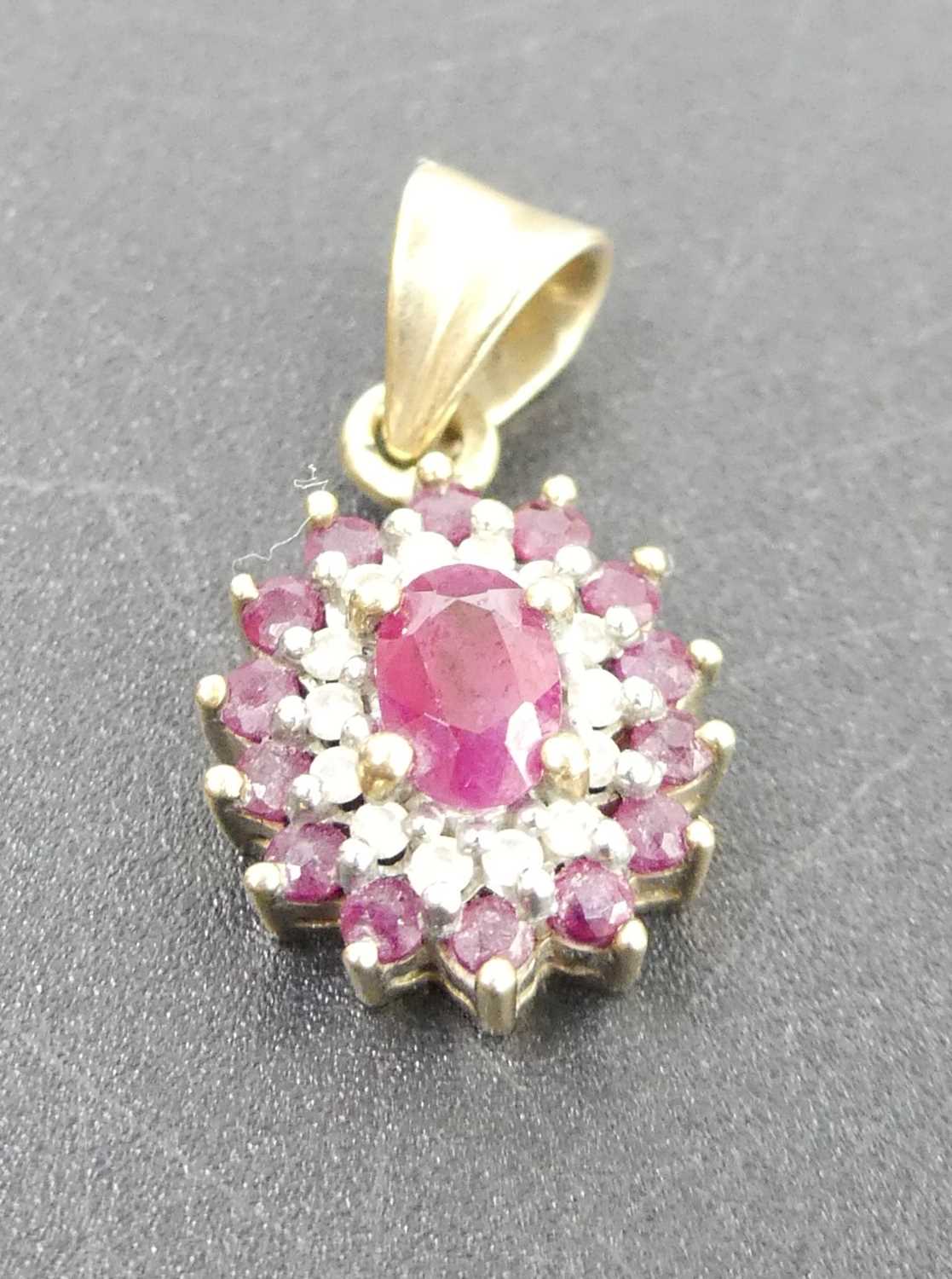 A modern 9ct gold, ruby and diamond point set flower head pendant, 2.2g, 14 x 10mm (excluding bale)