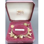 A modern 9ct gold bracelet, containing assorted principally 9ct gold charms, gross weight 20.1g