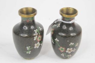 A pair of small Chinese cloisonne enamel vases, each decorated with flowers, h.10cm