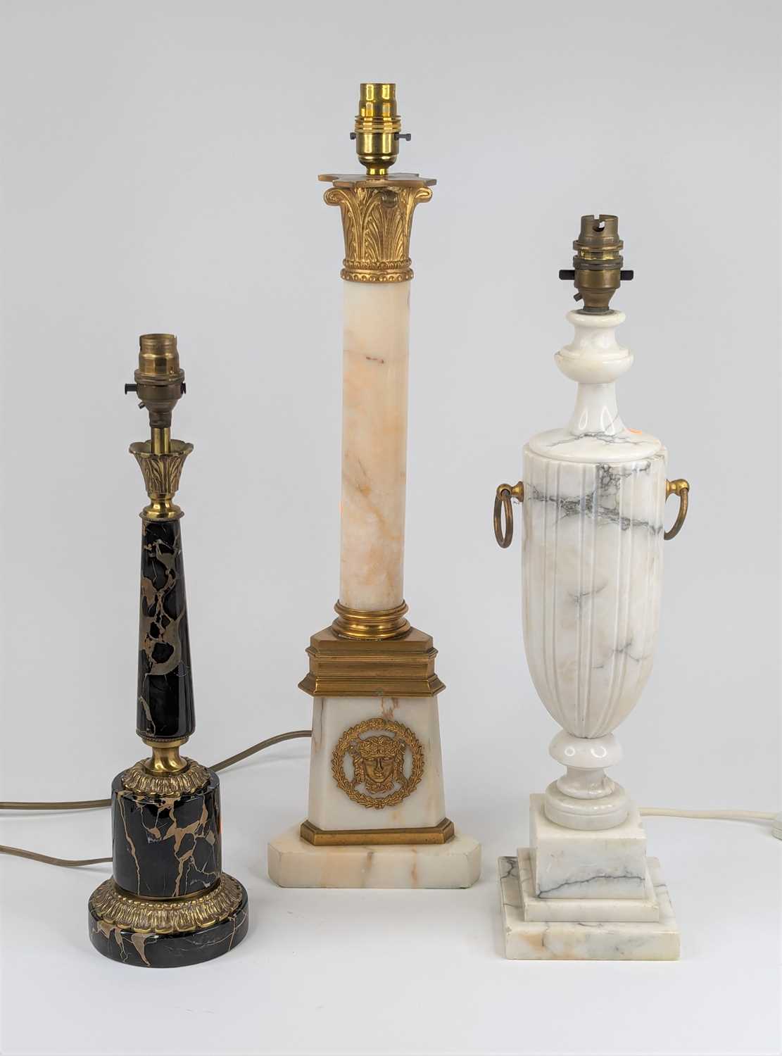 A collection of three polished hardstone table lamps the largest height 57cm