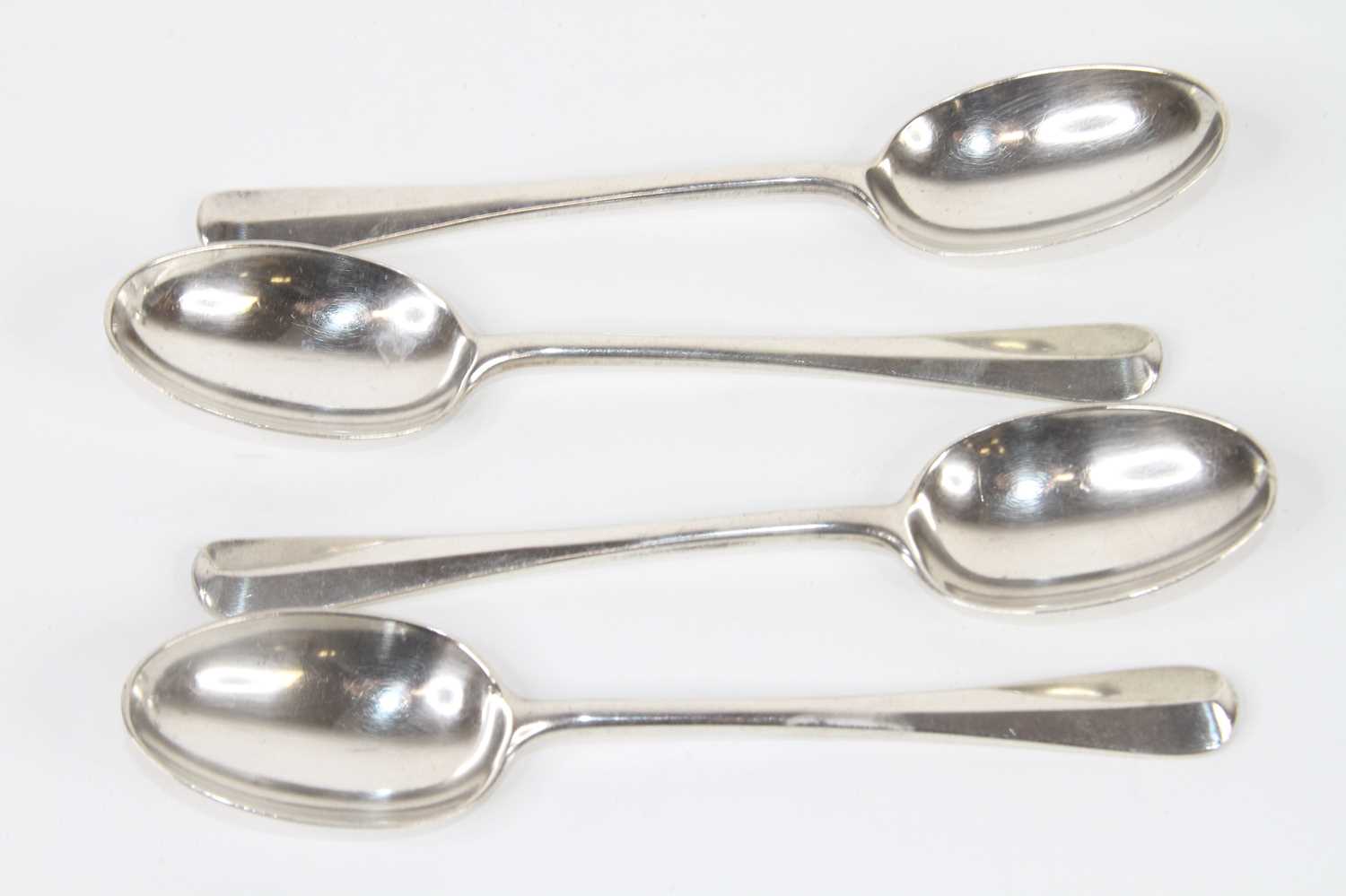 A set of four George V silver teaspoons in the Hanovarian Rat-tail pattern, maker Goldsmiths &