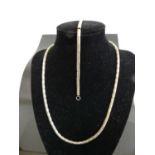 A contemporary Lavan Designer Jewellery silver necklace, having yellow metal ball dividers; together